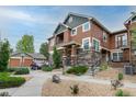 Beautiful townhome with stone accents, a private balcony, and a detached garage at 7130 Simms St # 206, Arvada, CO 80004