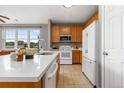 Bright kitchen with wood cabinets, stone countertops, and stainless steel appliances at 7130 Simms St # 206, Arvada, CO 80004
