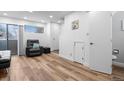 This cozy living room features hardwood floors, white walls, modern furnishings and plenty of natural light at 8701 Huron St # 1-212, Thornton, CO 80260