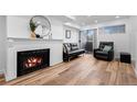Cozy living room features a fireplace, black leather sofa, and a sliding glass door to the outside at 8701 Huron St # 1-212, Thornton, CO 80260