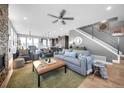 Open-concept living room with a cozy fireplace, hardwood floors, and modern decor at 2305 Quitman St, Denver, CO 80212