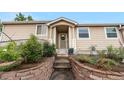 Charming single Gathering home with lovely front yard landscaping and welcoming front entry and covered porch at 2985 W 46Th Ave, Denver, CO 80211