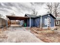 Exterior view of a charming blue home, complete with a covered parking area at 2852 W Ellsworth Ave, Denver, CO 80219