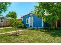Inviting blue home featuring a modern front door and well-maintained landscaping at 2852 W Ellsworth Ave, Denver, CO 80219