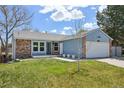 Charming single-Gathering home with brick and blue facade, well-kept lawn, and inviting entryway at 17476 E Bellewood Cir, Aurora, CO 80015