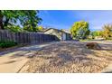 Side yard with gravel landscaping and wooden fence at 2519 S Sable Way, Aurora, CO 80014