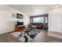 Cozy living room with a comfortable brown couch, a large window, and stylish decor at 2010 E 125Th Pl, Thornton, CO 80241