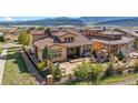 Aerial view of a backyard featuring a patio with an outdoor grill, fire pit, and mountain views at 15179 W Washburn Ave, Lakewood, CO 80228