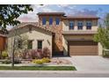 Charming two-story home with a stone facade, tile roof, and well-maintained landscaping at 15179 W Washburn Ave, Lakewood, CO 80228