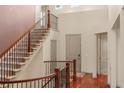 Elegant foyer featuring hardwood floors, staircase with iron railings, and a soaring two-story ceiling at 15179 W Washburn Ave, Lakewood, CO 80228