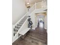 Entryway with hardwood floors, staircase, bench, and stylish cat tree, creating a welcoming first impression at 11093 Nome St, Commerce City, CO 80640