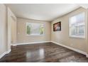 Bright living room featuring hardwood flooring, ample natural light, and neutral decor, great for relaxation at 11093 Nome St, Commerce City, CO 80640