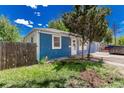 Blue home exterior with a fenced yard and landscaping, offering privacy and curb appeal at 770 Havana St, Aurora, CO 80010
