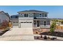 Charming two-story home showcasing a three-car garage and manicured front yard landscaping at 3453 N Gold Bug Ct, Aurora, CO 80019