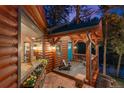 Cabin porch with flower boxes, blue door, and chairs, offering a cozy and inviting outdoor space at 30264 Upper Bear Creek Rd, Evergreen, CO 80439