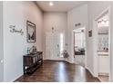 Bright entryway with hardwood floors, high ceilings, and access to a bathroom and sitting room at 3375 Starry Night Loop, Castle Rock, CO 80109