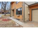 Close up on the exterior featuring warm siding and a two-car garage at 12655 W Bayaud Ave # 40, Lakewood, CO 80228