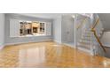 Bright living room featuring hardwood floors, staircase, and a large window at 12655 W Bayaud Ave # 40, Lakewood, CO 80228