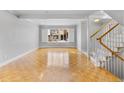 Bright living room with parquet floors, large windows, and stairs to the upper level at 12655 W Bayaud Ave # 40, Lakewood, CO 80228