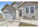 Charming single-story home with a two-car garage, cozy front porch with seating, and well-maintained lawn at 6320 Indian Paintbrush St # 108, Frederick, CO 80530