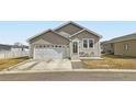 Charming single-story home with a two-car garage, cozy front porch, and well-maintained lawn at 6320 Indian Paintbrush St # 108, Frederick, CO 80530