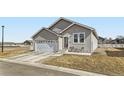 Charming single-story home with a two-car garage, cozy front porch, and well-maintained lawn at 6320 Indian Paintbrush St # 108, Frederick, CO 80530