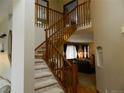 Elegant foyer with a staircase featuring wooden railings and a view of the living room at 9684 W Long Dr, Littleton, CO 80123