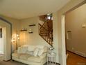 Cozy living room with a comfortable sofa, stylish lighting, and a view of the staircase at 9684 W Long Dr, Littleton, CO 80123