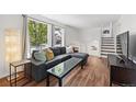 Bright living room with hardwood floors and a large window offering a pleasant view of the outdoors at 11041 Newland St, Westminster, CO 80020