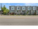 Contemporary townhome exterior showcasing modern architecture with multiple windows and professionally landscaped frontage at 8711 E Hampden Ave # 6, Denver, CO 80231