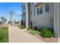Townhome featuring modern design, large windows, and landscaped front yard along a sidewalk at 8711 E Hampden Ave # 6, Denver, CO 80231