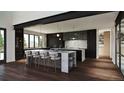 Spacious kitchen with modern appliances, large island, dark cabinetry, and stylish lighting at 5052 Nile Ct, Golden, CO 80403