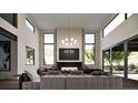 Elegant living room with fireplace, floor-to-ceiling windows, and comfortable seating at 5052 Nile Ct, Golden, CO 80403