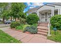 Charming home with well-maintained landscaping and a cozy entrance, evoking a sense of warmth and curb appeal at 1038 E 4Th Ave, Denver, CO 80218