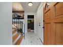 Welcoming entryway features modern geometric tile flooring and a convenient coat closet for storage at 116 Monarch St, Louisville, CO 80027