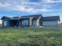 Expansive backyard featuring a lush lawn and patio area, perfect for outdoor entertaining at 6736 S Flanders Ct, Aurora, CO 80016