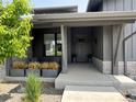 Inviting front porch with decorative planters and stylish gray trim at 6736 S Flanders Ct, Aurora, CO 80016