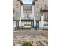 Contemporary townhome facade featuring multiple balconies, a well-kept lawn, and a stylish entrance area at 3109 W Bates Ave, Denver, CO 80236