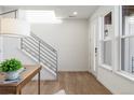 Welcoming home foyer features hardwood floors, modern staircase, and plenty of natural light at 3109 W Bates Ave, Denver, CO 80236