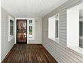 Covered front porch area with wood flooring at 1050 S Monaco Pkwy # 125, Denver, CO 80224