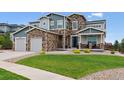 Charming two-story home with stone accents, well-kept lawn, and inviting curb appeal at 21854 Tyrolite Ave, Parker, CO 80138