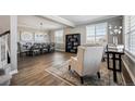 Bright living room featuring hardwood floors, large windows, and a decorative chandelier at 21854 Tyrolite Ave, Parker, CO 80138