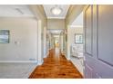 Welcoming foyer with hardwood floors and neutral-toned walls, leading into the carpeted living space at 2861 Eagle Cir, Erie, CO 80516