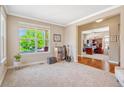 Inviting living room with large windows and neutral carpet, offering great natural light at 2861 Eagle Cir, Erie, CO 80516