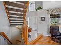 Bright foyer with staircase and elegant tile leading to the front door at 5706 S Garland Way, Littleton, CO 80123