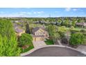 Aerial view of a home and its surrounding neighborhood, showcasing landscaping and community at 22302 Quail Run Way, Parker, CO 80138