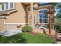 Close-up view of front entrance, showcasing stone accents, landscaping, and seating area at 22302 Quail Run Way, Parker, CO 80138