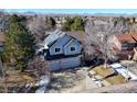 An aerial view of a two-story home with solar panels and a three-car garage at 6148 W Pacific Cir, Lakewood, CO 80227