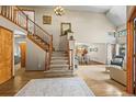 Bright entryway with hardwood floors, staircase, and views to living areas at 6148 W Pacific Cir, Lakewood, CO 80227