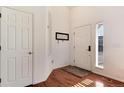 Bright entryway with hardwood floors, a coat closet, and natural light at 6313 E 130Th Ave, Thornton, CO 80602